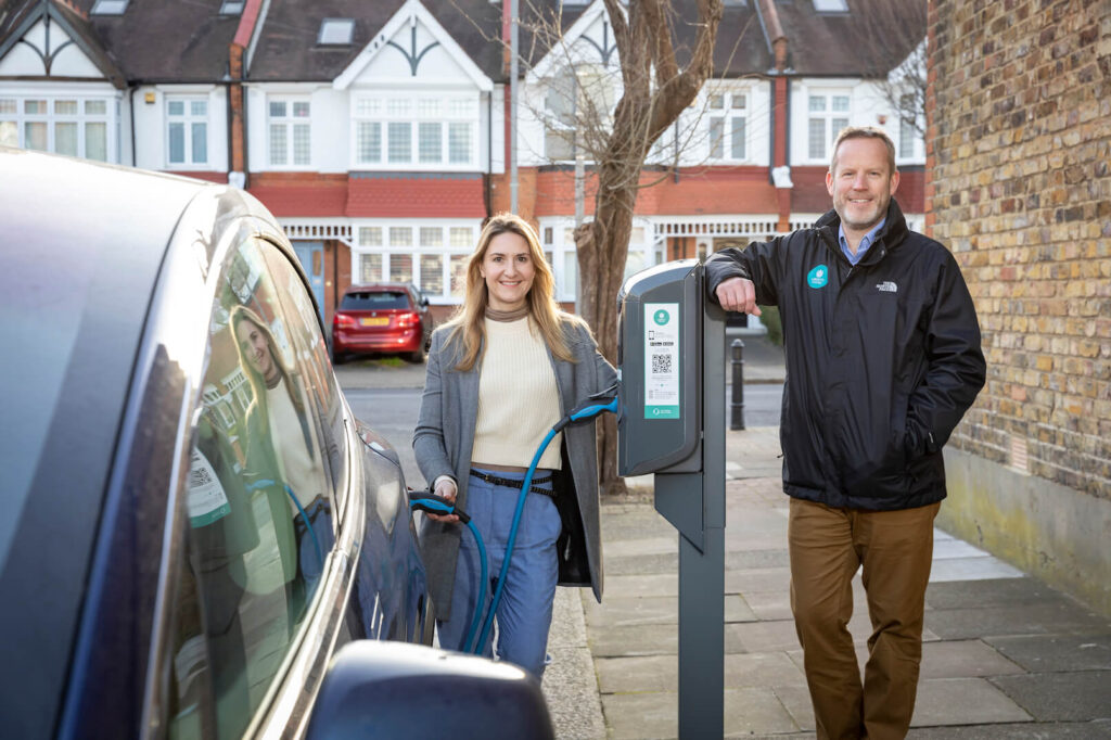 Woman charging a car witch charge point