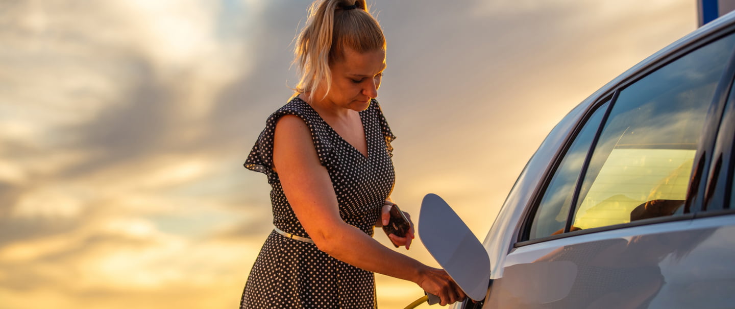 A woman and an electric car