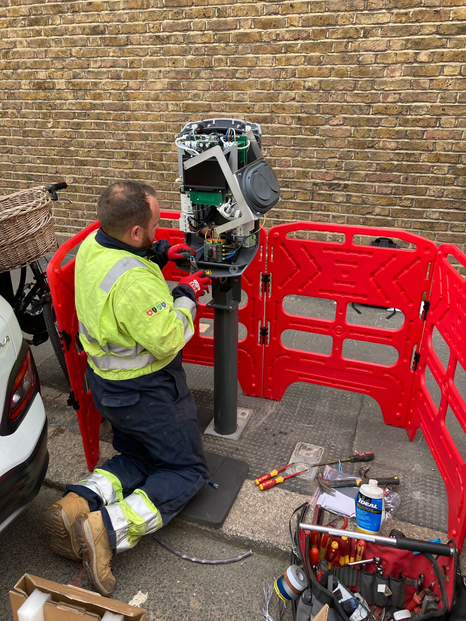 Man repairing the car's charging point