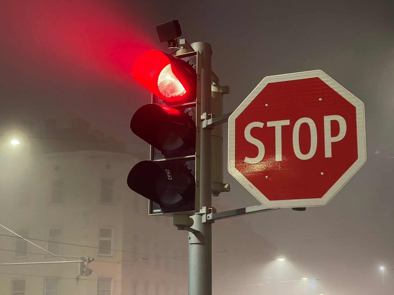 Red traffic light and stop road sign