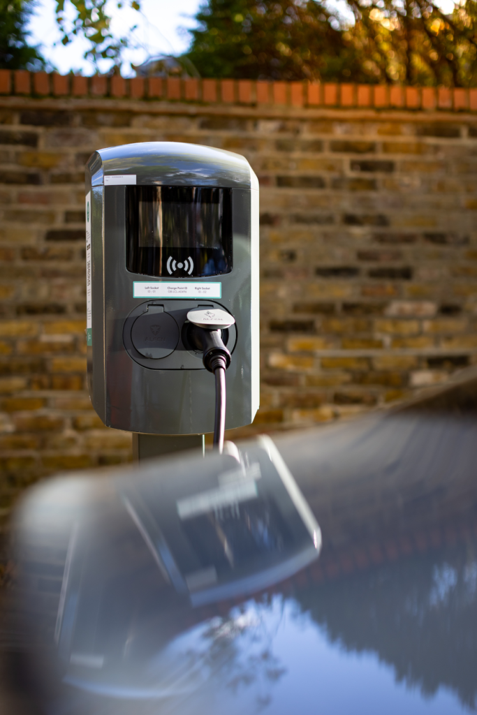 Charge point and red brick wall in the background